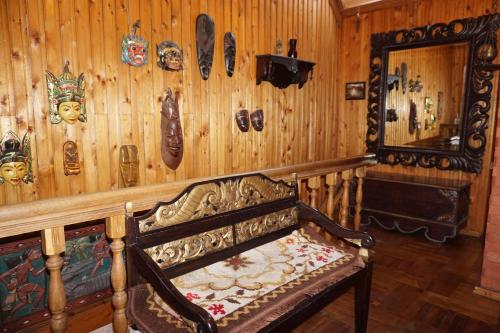 a room with a wooden wall with a bench and a mirror at Pas Birute in Kaunas