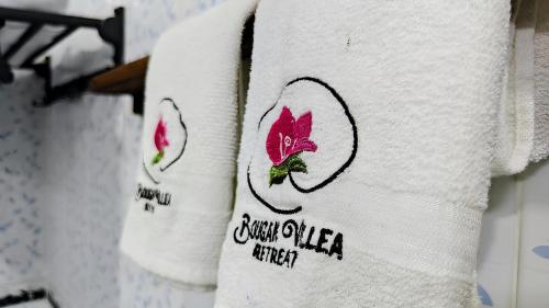 a stack of towels on a rack in a store at Bougan Villea Retreat in Bodufolhudhoo