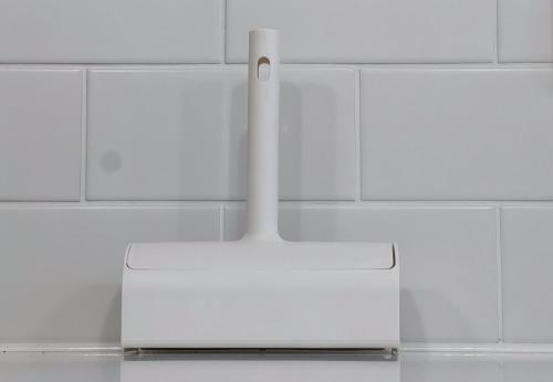 a white kitchen with white tiles on the wall at trias 102 in Tokyo