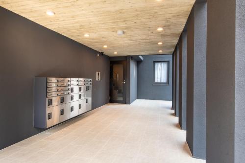a hallway with a wall of wine bottles at trias527 2-2 in Tokyo
