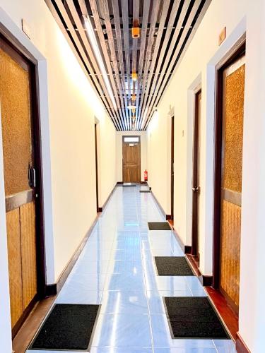 a corridor of an office building with a tile floor at Bougan Villea Retreat in Bodufolhudhoo