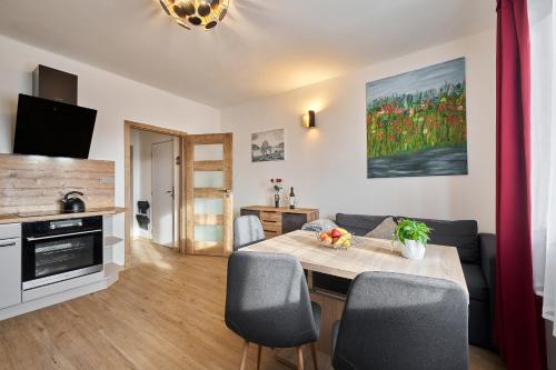 a living room with a dining room table with chairs at Apartmán - Dovolená Žacléř in Žacléř
