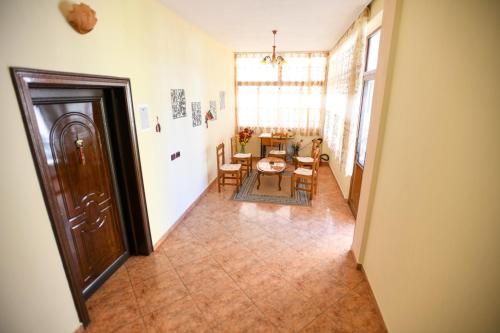 a hallway with a table and chairs in a room at Guesthouse Alemannia in Berat