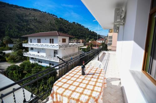 a balcony with a table and a view of a building at Guesthouse Alemannia in Berat