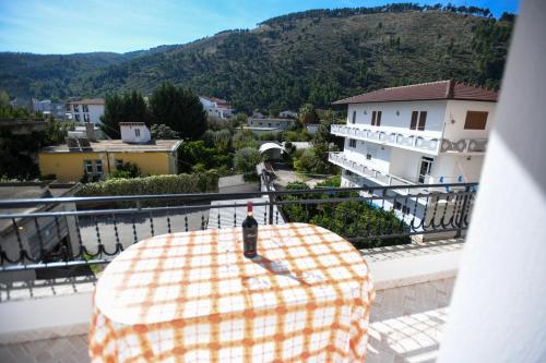 a table on a balcony with a view of a city at Guesthouse Alemannia in Berat