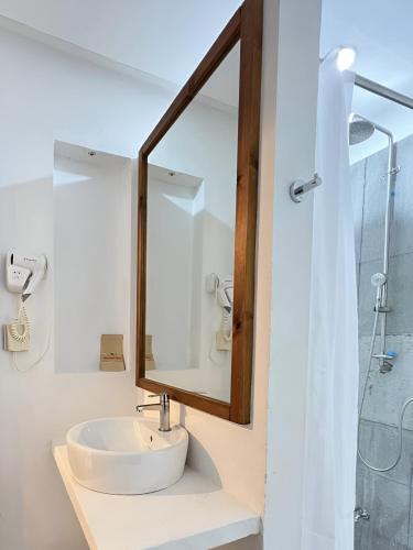 a bathroom with a sink and a mirror at Bougan Villea Retreat in Bodufolhudhoo