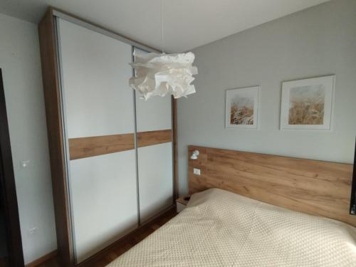 a bedroom with a bed and a chandelier at Maršal, Titova vila in Zlatibor