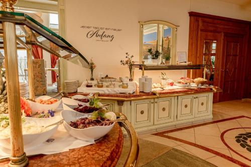 a kitchen with bowls of food on a table at Rugard Thermal Strandhotel in Binz