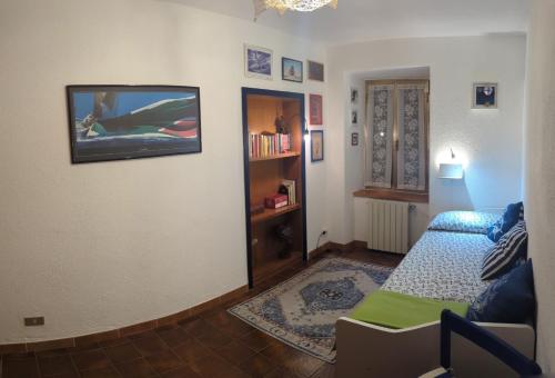 a living room with a bed and a tv on the wall at Casa Vacanza San Piero in San Piero in Campo