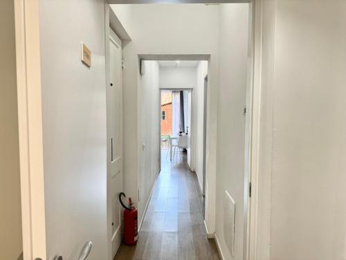 a hallway with white walls and a red fire hydrant at Relais Stibbert Florence in Florence