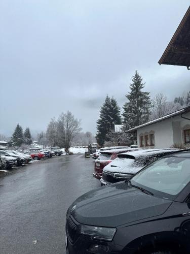 a parking lot with cars covered in snow at Landhotel Älpili in Gaschurn
