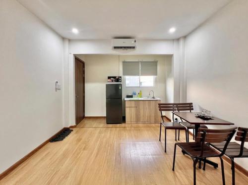 a kitchen and dining room with a table and chairs at Cozy Home Airport - Self check-in 247 in Ho Chi Minh City