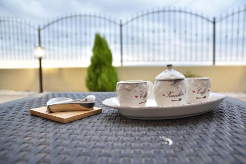 two tea cups and a plate on a table at Mareluna in Torremaggiore