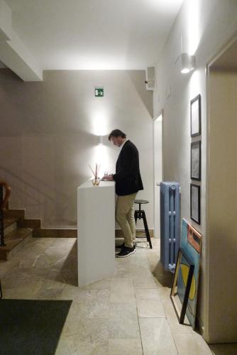 a man standing at a table in a room at Relais Stibbert Florence in Florence