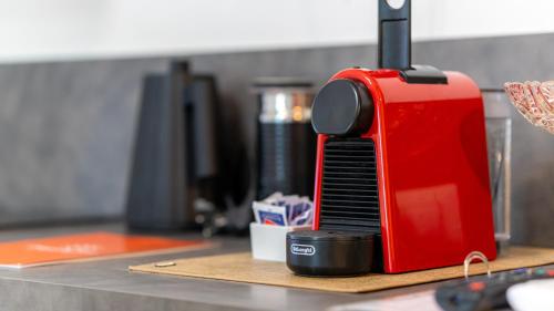a red toaster sitting on top of a counter at La dimora del barone in Salerno