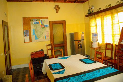 a bedroom with a table and a cross on the wall at Maison d'Accueil - Fondation San Filippo Neri in Bujumbura