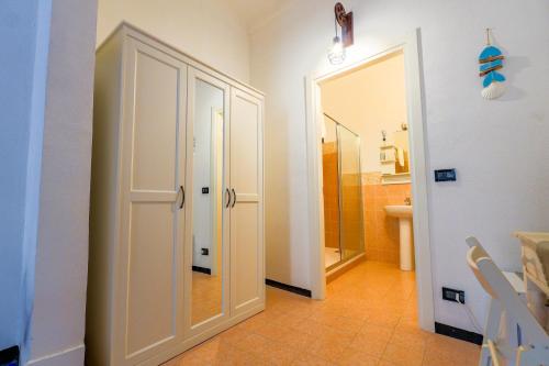 a bathroom with a toilet and a shower and a door at White Lerici in Lerici