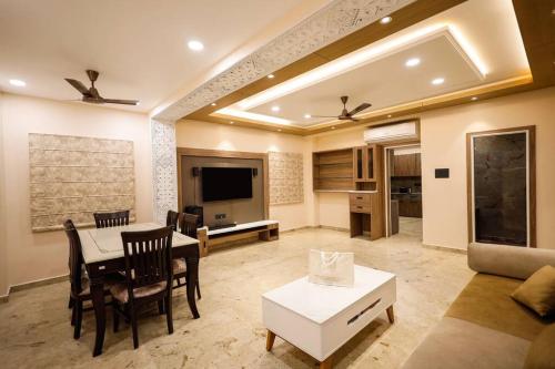 a living room with a table and a couch at Myestay Elite The Ultimate Luxury Spacious Villa in Varanasi