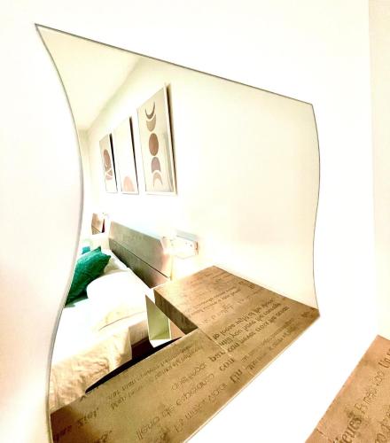 a mirror reflection of a bedroom with a bed at MaryGrace B&B in Castellammare di Stabia