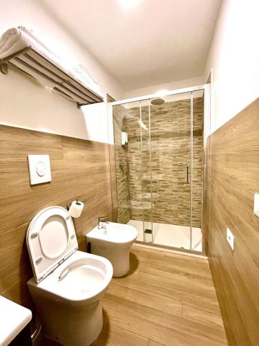 a bathroom with a toilet and a sink and a shower at MaryGrace B&B in Castellammare di Stabia