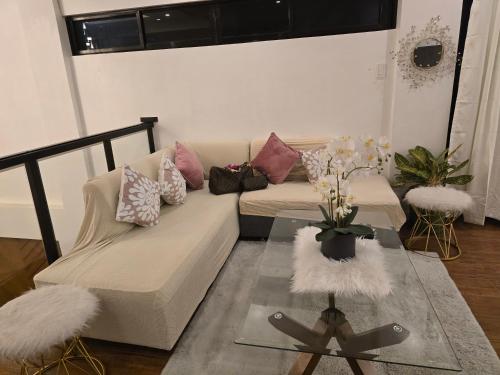 a living room with a couch and a glass table at Home in Bacolod in Bacolod