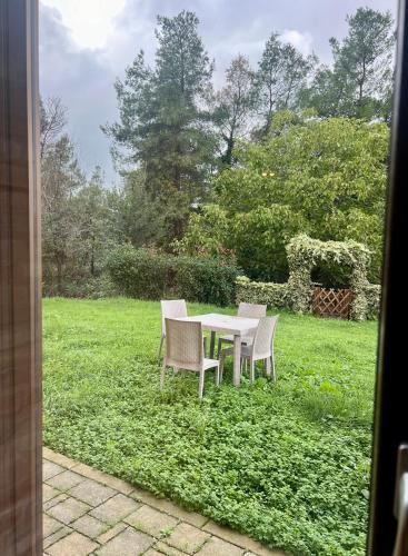 a table and chairs in a field of grass at Tenuta Gran Bosco in Loro Piceno