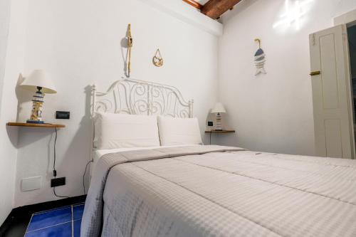 a white bedroom with a bed with a white bedspread at White Lerici in Lerici