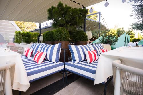 a row of blue and white striped pillows on a patio at Crowne Plaza Belgrade by IHG in Belgrade