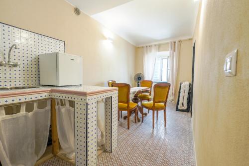 a kitchen and dining room with a table and chairs at White Lerici in Lerici