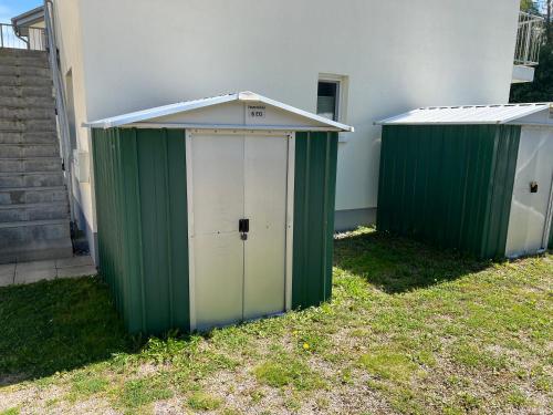 two green and white toilets sitting next to a building at Hasenwinkel 6 in Gelbensande