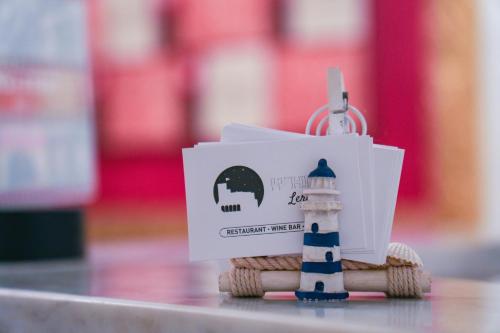 a key chain with a lighthouse on top of a table at White Lerici in Lerici