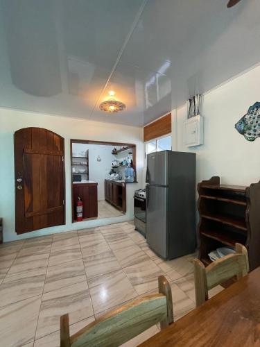 a kitchen with a stainless steel refrigerator and a table at Casa Blanca Beachfront House with Shared Pool Access Pangea Lodge in Manzanillo