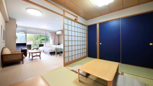 a living room with a room with a room with at Reyzenit Kinosaki Suite VILLA in Toyooka