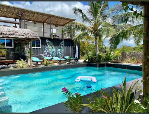 a swimming pool with a float in the middle at Jambiani Backpackers Hostel in Jambiani