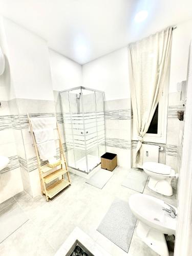 a bathroom with a shower and a toilet and a sink at The Center Residence in Genoa