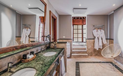 a bathroom with two sinks and a large mirror at Melia Villaitana in Benidorm