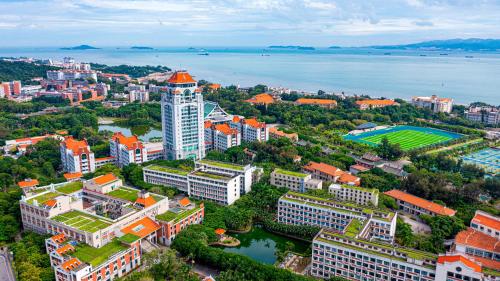 an aerial view of a city with buildings and water at Xiamen Zhongshan Road Pedestrian Street Qulistar Hotel in Xiamen