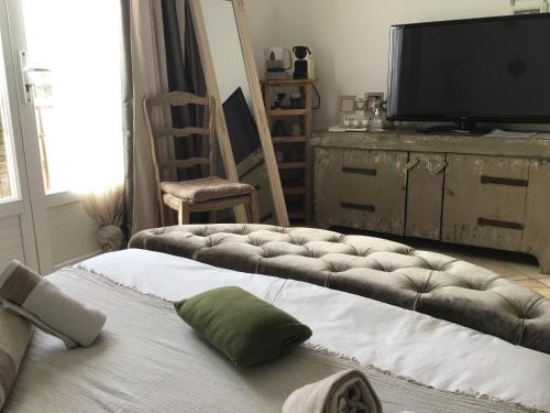 a living room with a couch and a flat screen tv at Villa fiora chambre in Martigues