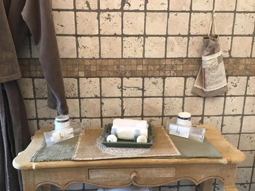 a table with a box of towels and two bags on it at Villa fiora chambre in Martigues