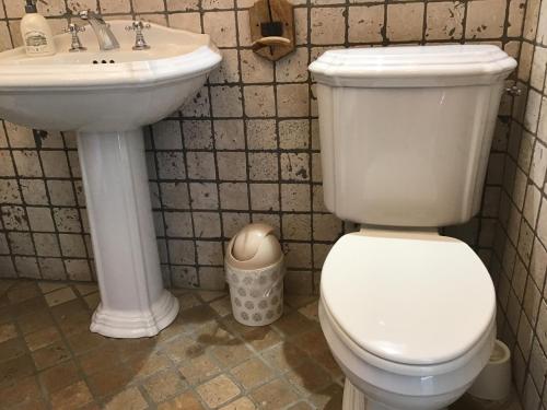a bathroom with a white toilet and a sink at Villa fiora chambre in Martigues