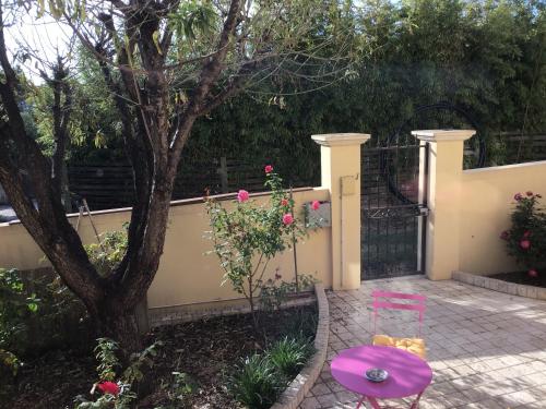 a teddy bear sitting on a table next to a fence at Villa fiora chambre in Martigues