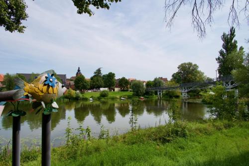a river with a statue of a bunch of bananas at Das BilderbuchCafe - Ferien Apartment NO 5 - Markt 7 in Havelberg