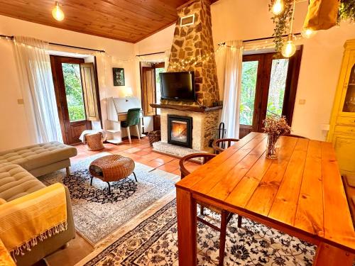 a living room with a wooden table and a fireplace at Villa Esquina 204 - Connected With Nature- uChill in Riba de Âncora