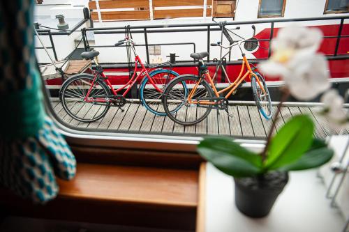 a group of bikes parked on a balcony at Amsterdam Hotelboat in Amsterdam