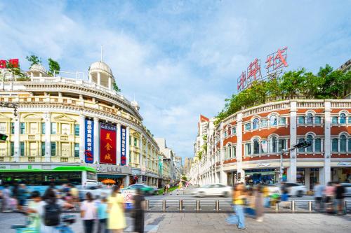 a crowd of people walking on a busy city street at Xiamen Zhongshan Road Pedestrian Street Qulistar Hotel in Xiamen