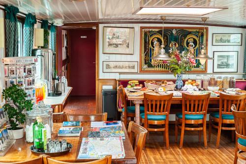 a dining room with a table and chairs at Amsterdam Hotelboat in Amsterdam