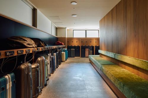 a room with rows of luggage racks in a gym at Hotel Grand Bach Kyoto Select in Kyoto