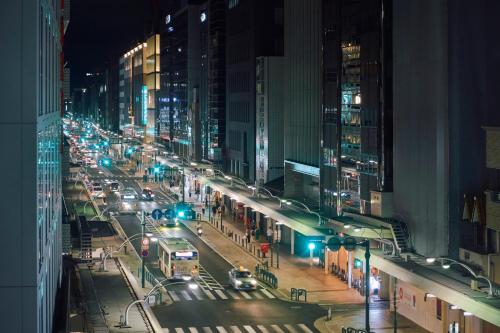 a busy city street at night with traffic at Hotel Grand Bach Kyoto Select in Kyoto
