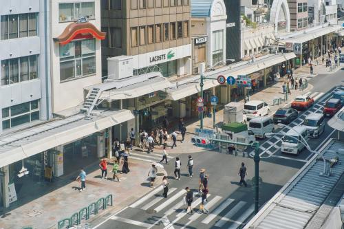 a group of people crossing a busy city street at Hotel Grand Bach Kyoto Select in Kyoto