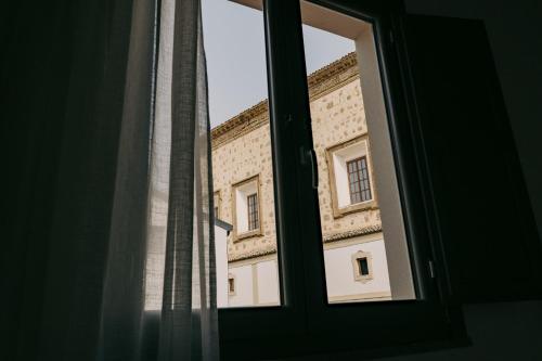 an open window with a view of a building at Spasimo Hôtellerie in Palermo